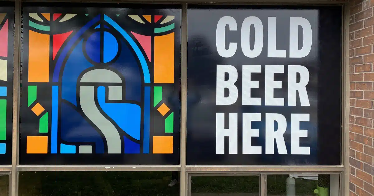 colorful window graphics from outside of silversmith brewing co. church inspired