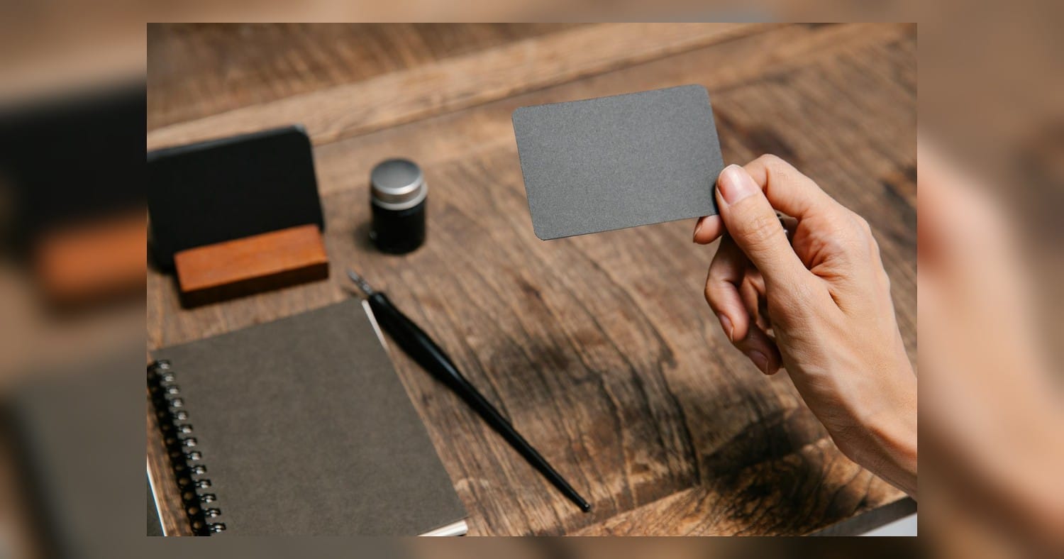 Business Cards Guide: stacks of business cards on an office desk next to a printer and display rack