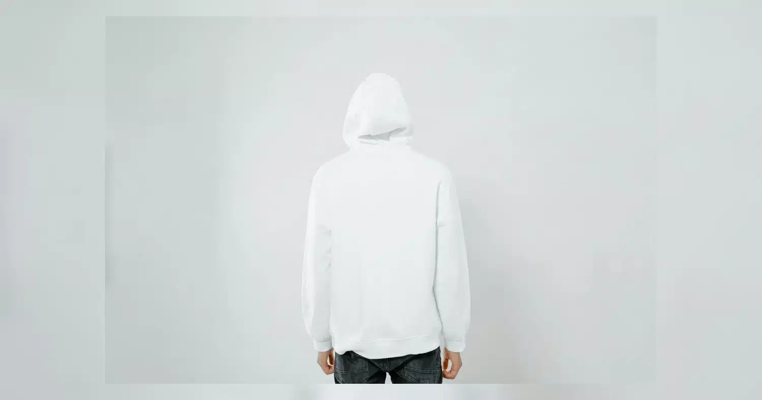 Embroidered vs Printed Hoodies — Person wearing a white hoodie facing away against a plain backdrop, offering blank space.