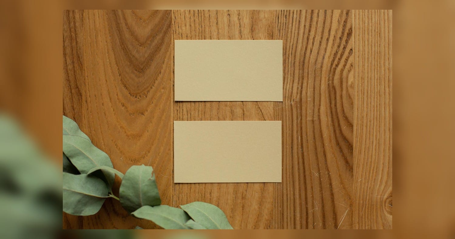 Business Card Design Tips shown on a set of minimalist card mockups on a clean wooden workspace with printing tools