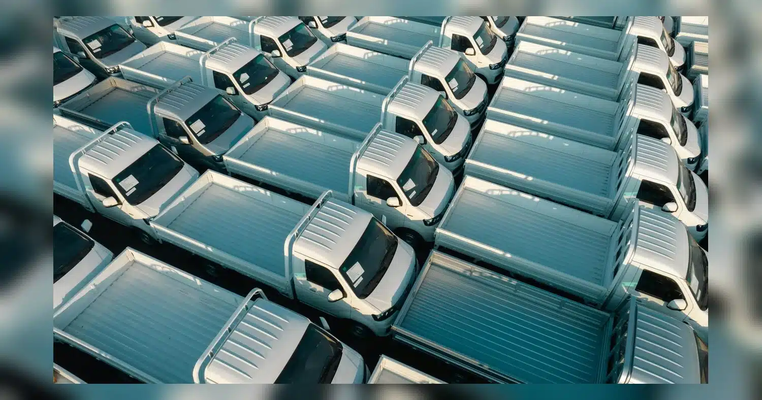 Types of Truck Decals — Aerial view of white pickup trucks parked in rows, emphasizing symmetry and industrial style.