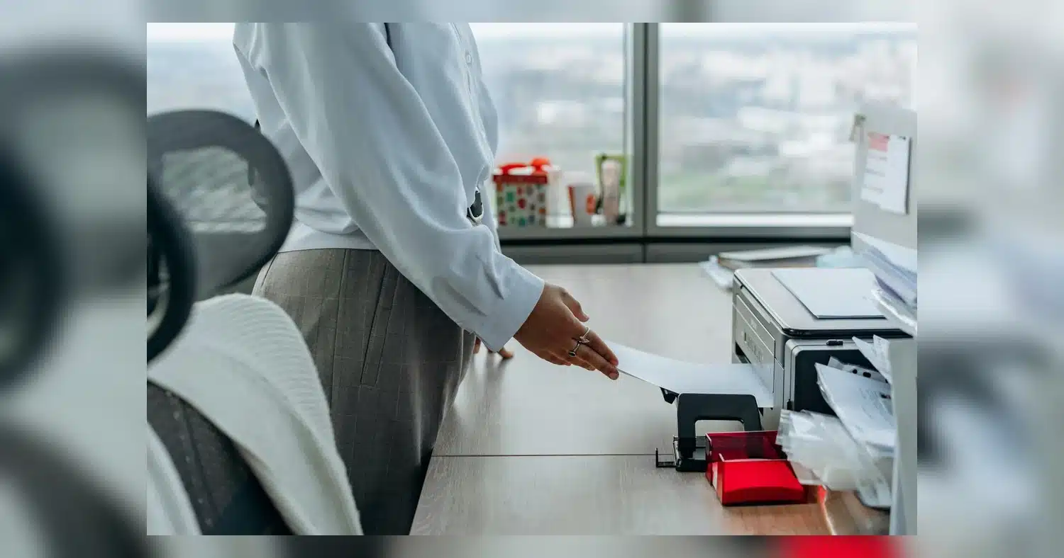 rush printing near humber college — Business professional printing a document in an office environment.
