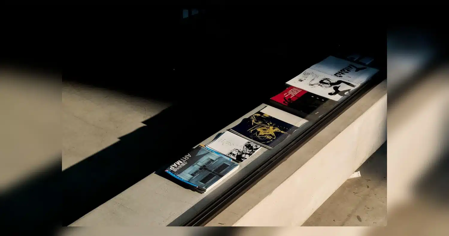 same day printing printing near humber college — Art magazines and brochures on a sunlit concrete surface, highlighting shado