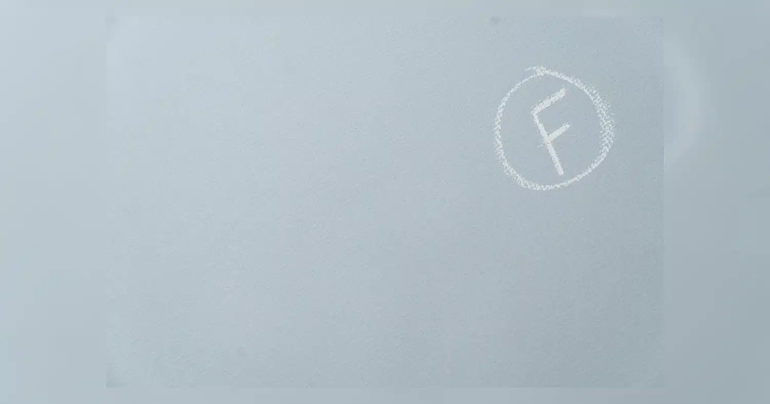 Cast vs calendered vinyl wraps - close-up of vinyl film application on a vehicle panel