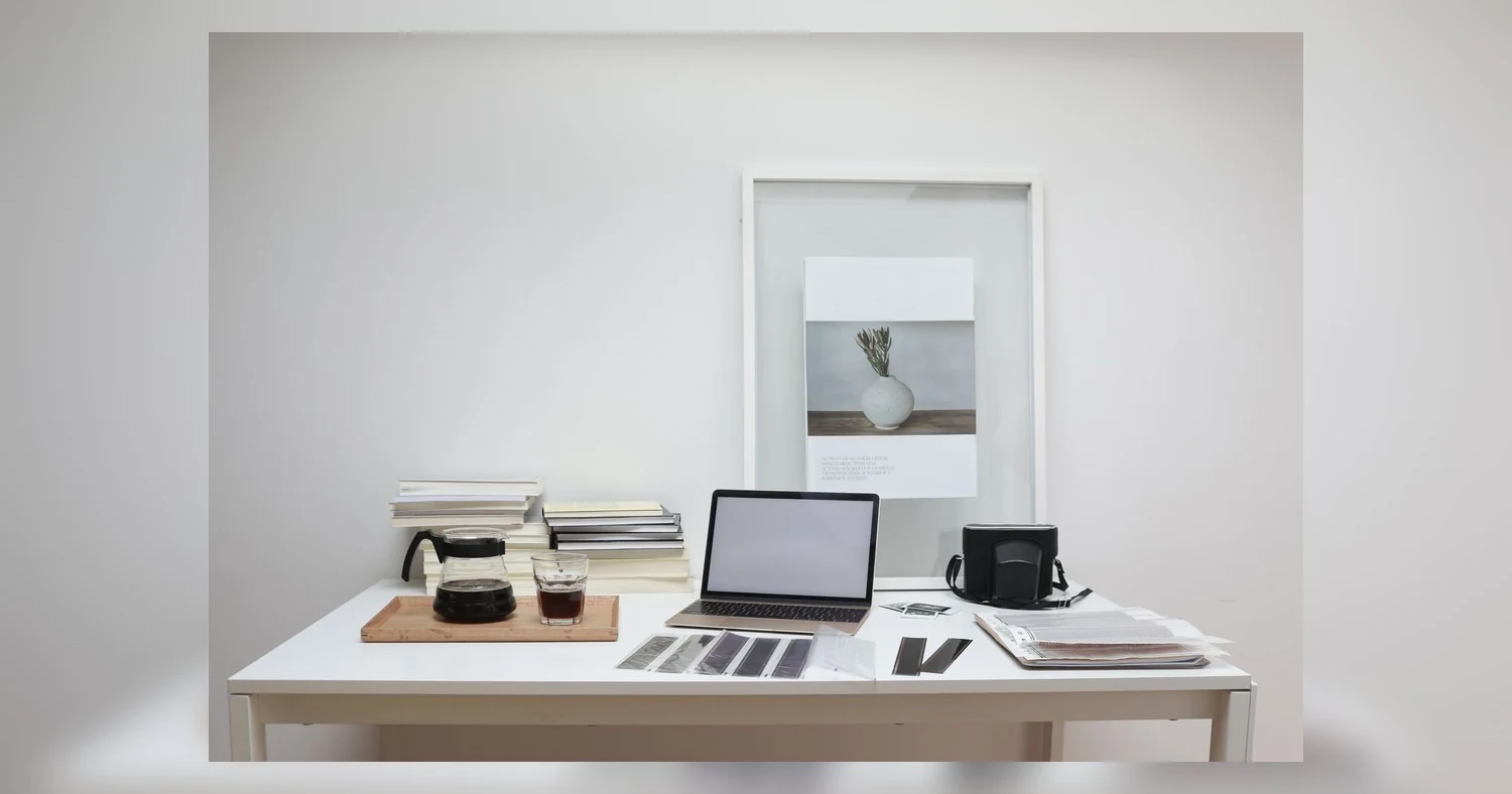 custom apparel printing options — Modern laptop with blank screen arranged with retro filmstrips photo camera and framed pict