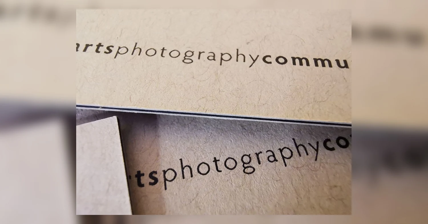 business card paper weight — Detailed close-up image of text on a business card, featuring words related to photography and c