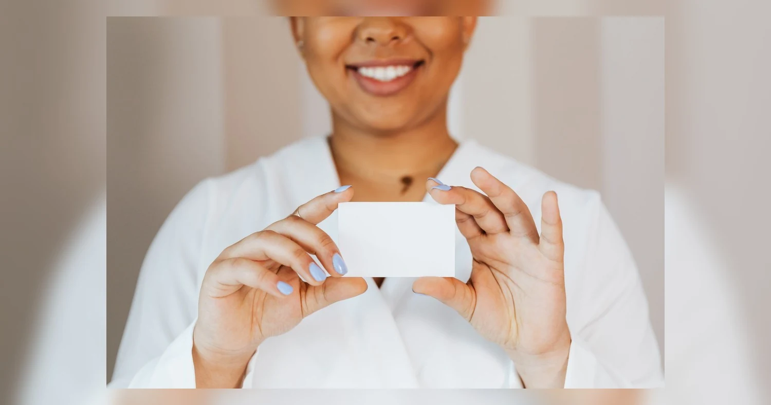 business card paper weight — African American woman smiling, holding a blank card in hands, ready for branding or mockup.