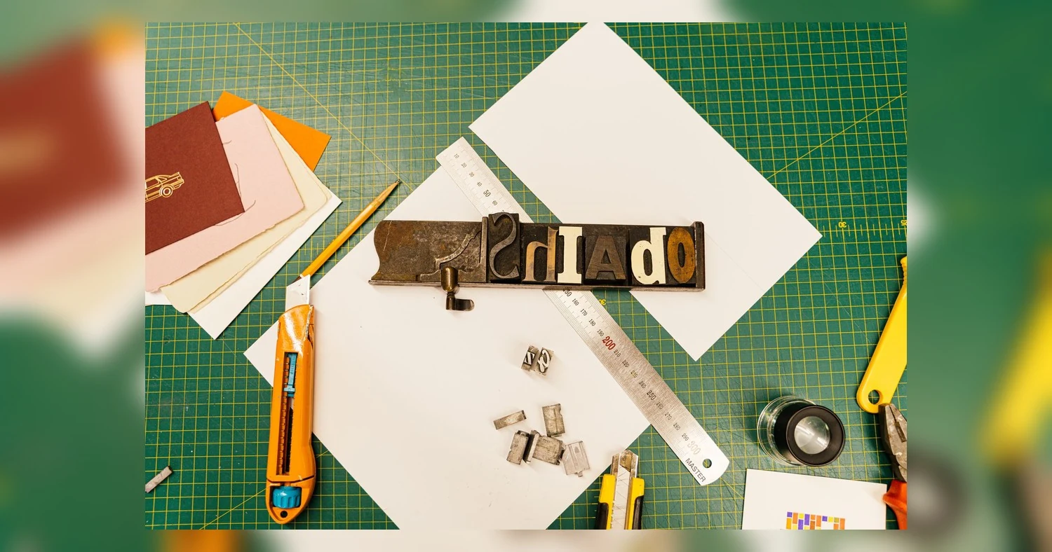 print ready file setup — A top-view image of letterpress tools and paper materials for creative printmaking projects.