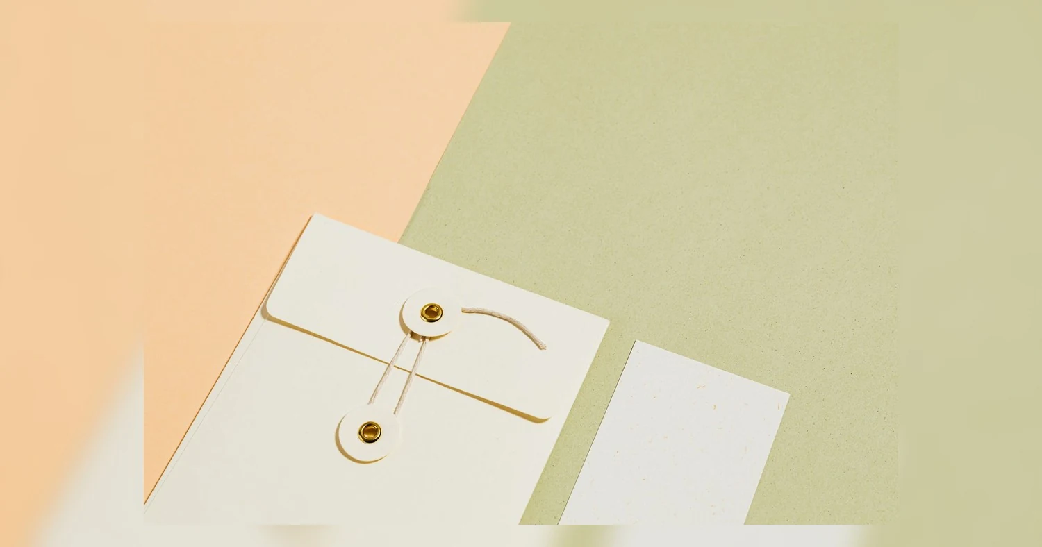 letterhead printing Toronto — Minimalist stationery flat lay featuring an envelope and card on a pastel background.